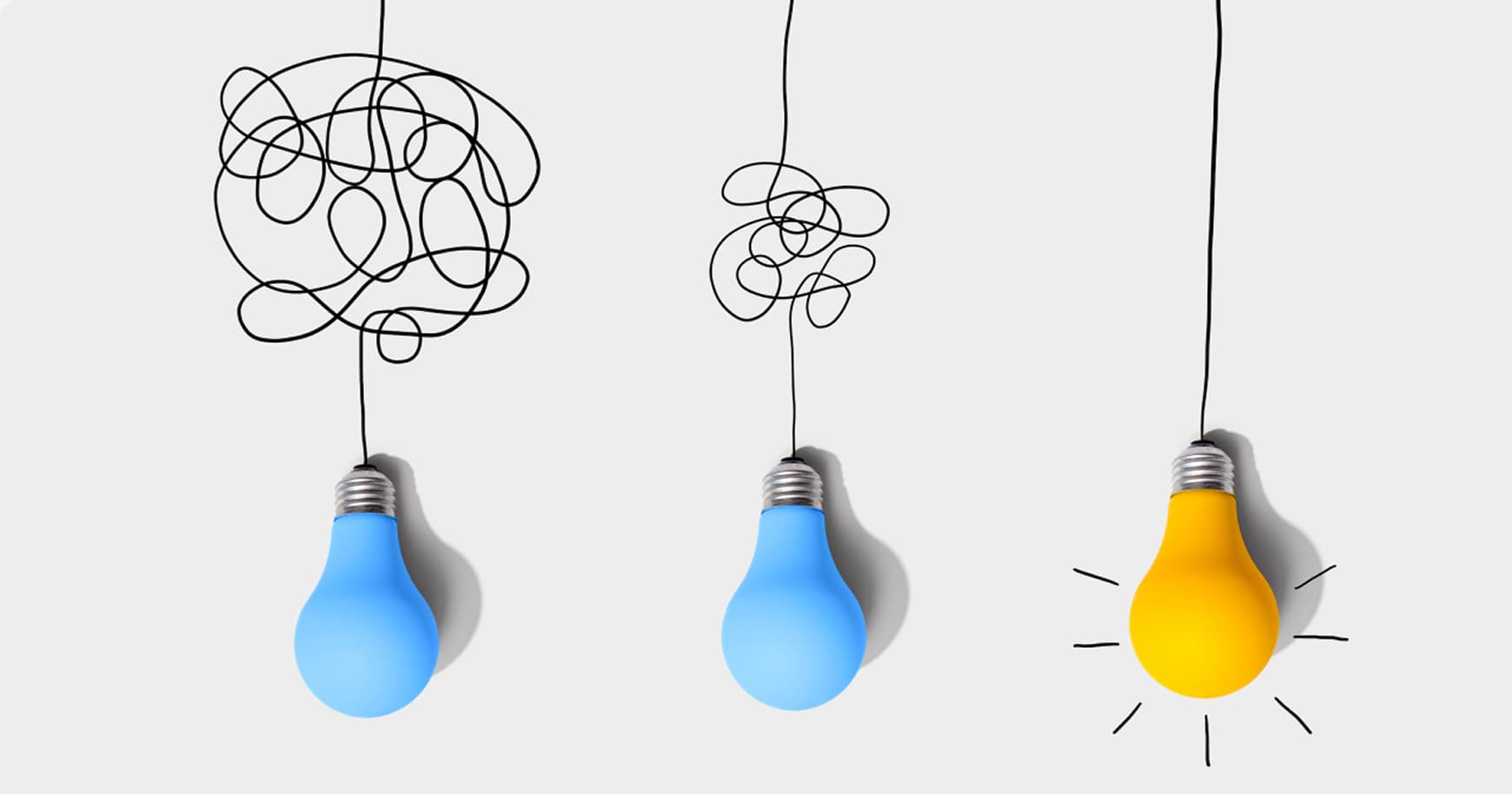 Two blue lightbulbs with tangled wires representing unclear ideas and one yellow lightbulb with a straight wire and glowing lines around the bulb symbolizing the chosen concept.